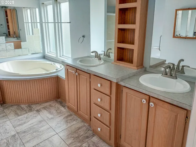 a bathroom with a granite countertop sink a toilet and shower