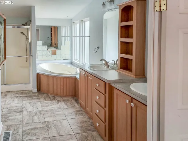 a bathroom with a tub and shower
