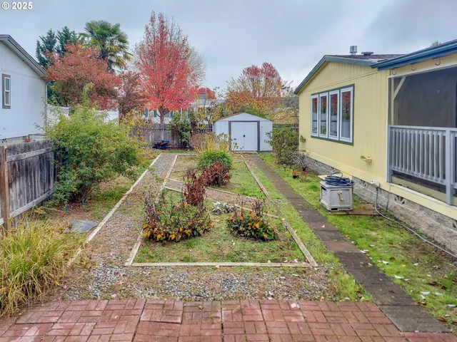 a view of a house with a yard and garden