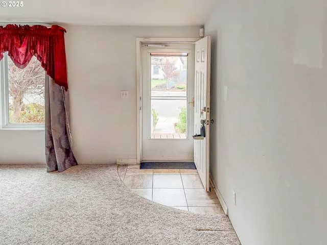 a view of an empty room with a window