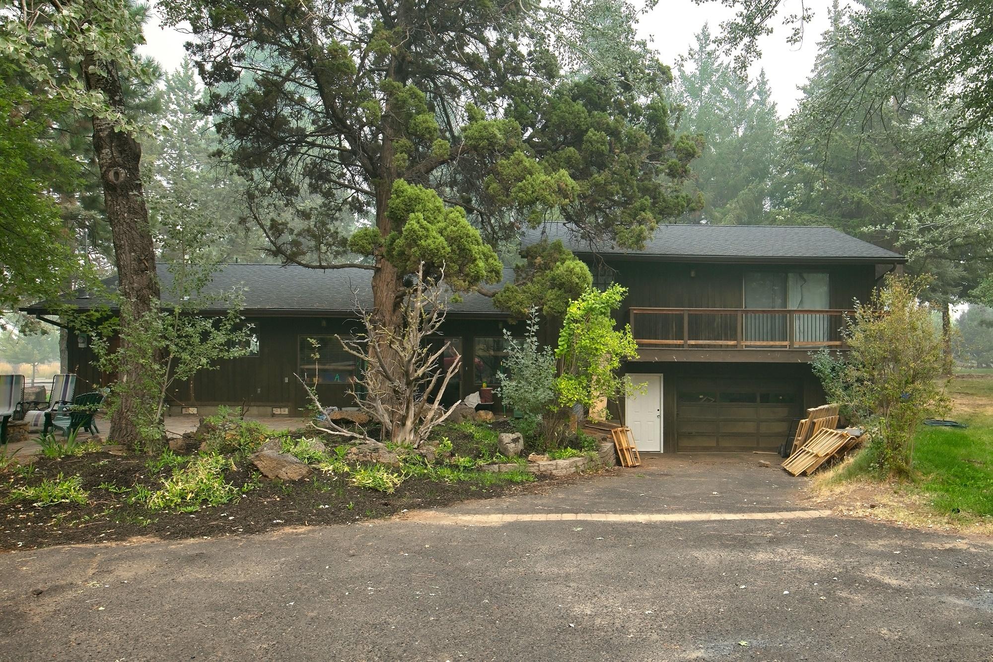 21133 Bear Creek Road Bend, OR 97702 - Photo 6 of 23 Rear of home with garage entry.