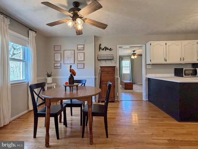 a kitchen with granite countertop white cabinets and sink