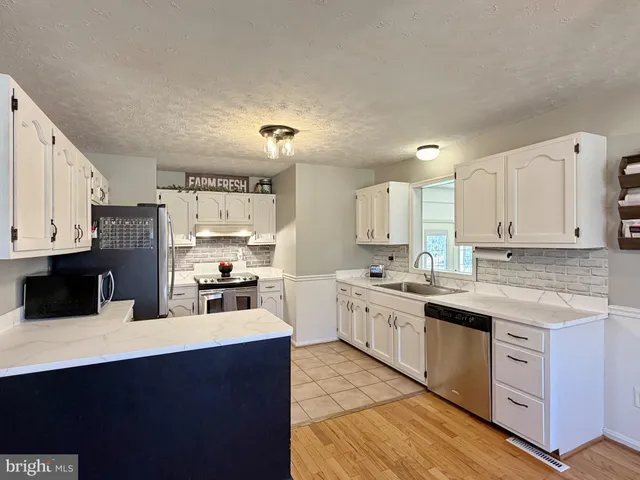 a kitchen with a stove and a sink