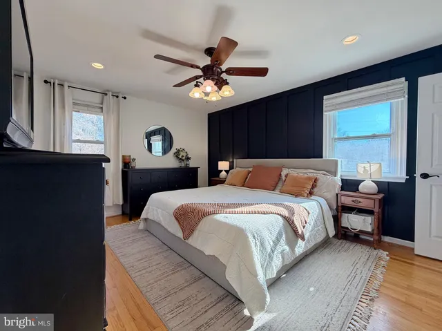 a bathroom with a granite countertop toilet sink and mirror