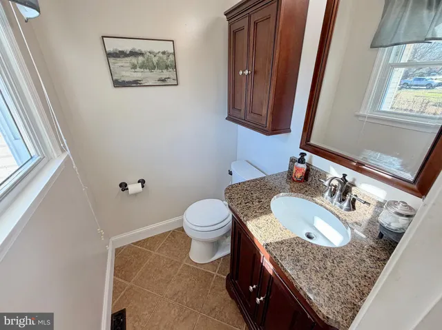 a view of a hallway to a house with stairs