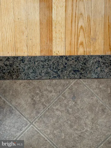 a view of a livingroom with wooden floor and a window