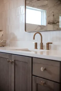 a view of a patio with table and chairs potted plants and floor to ceiling window