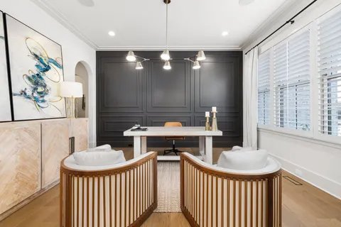 a kitchen with kitchen island granite countertop a table chairs sink and wooden floor