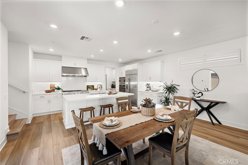 312 Merit Irvine, CA 92618 - Photo 12 of 46 a view of a dining room and kitchen with a table chairs