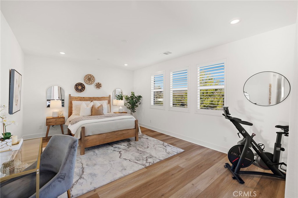312 Merit Irvine, CA 92618 - Photo 20 of 46 a bedroom with a bed a table and chair with wooden floor