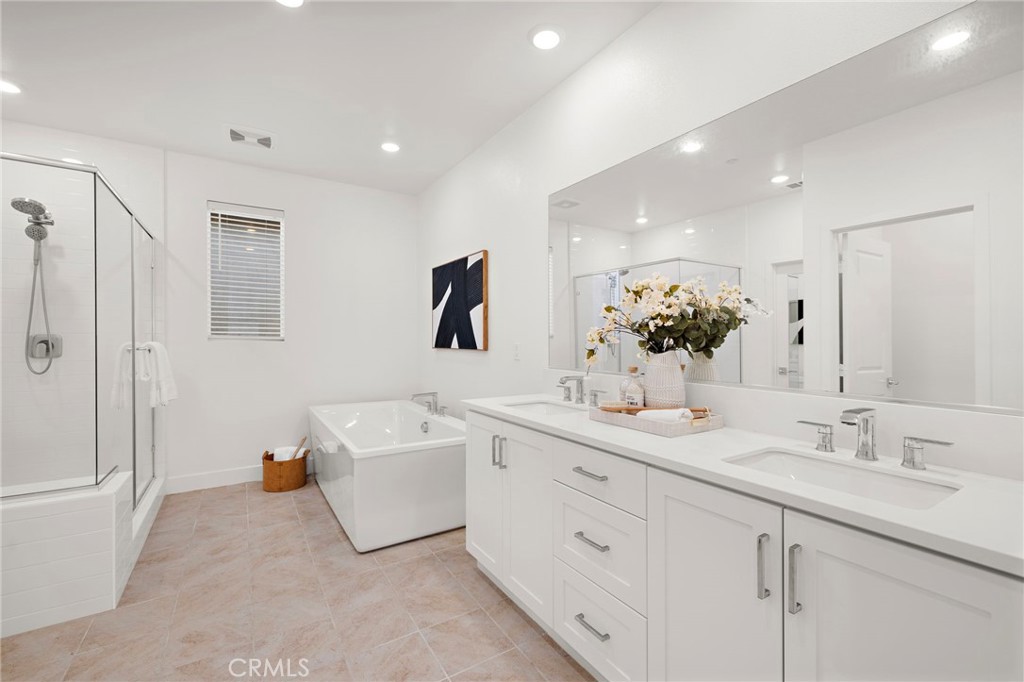 312 Merit Irvine, CA 92618 - Photo 23 of 46 a spacious bathroom with a double vanity sink mirror and bathtub