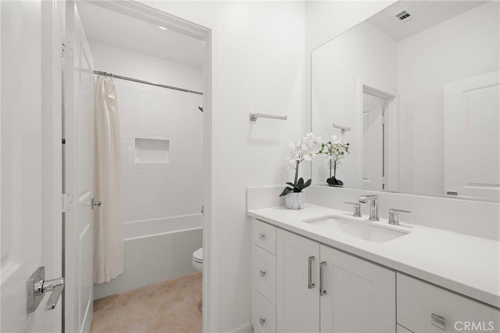 312 Merit Irvine, CA 92618 - Photo 27 of 46 a bathroom with a shower sink vanity and mirror