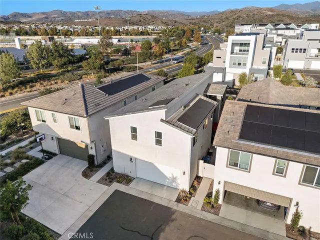 an aerial view of a residential building and parking space