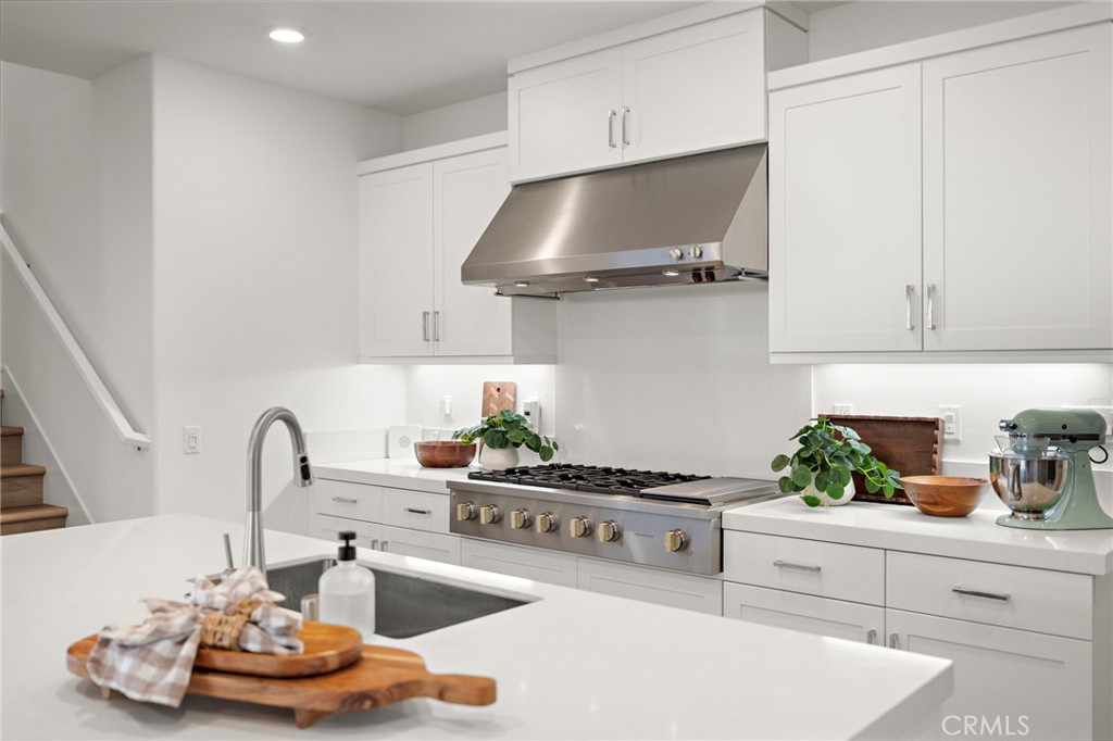 312 Merit Irvine, CA 92618 - Photo 8 of 46 a kitchen with stainless steel appliances a sink and cabinets