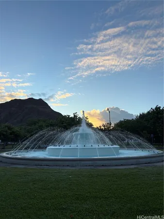 a view of a big yard with an ocean view
