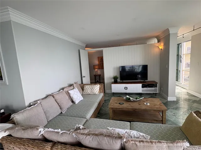 a living room with furniture and a flat screen tv