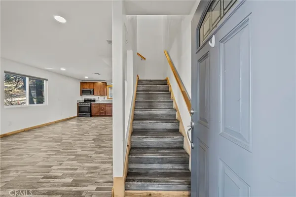 a large kitchen with stainless steel appliances granite countertop a large counter top and a stove top oven