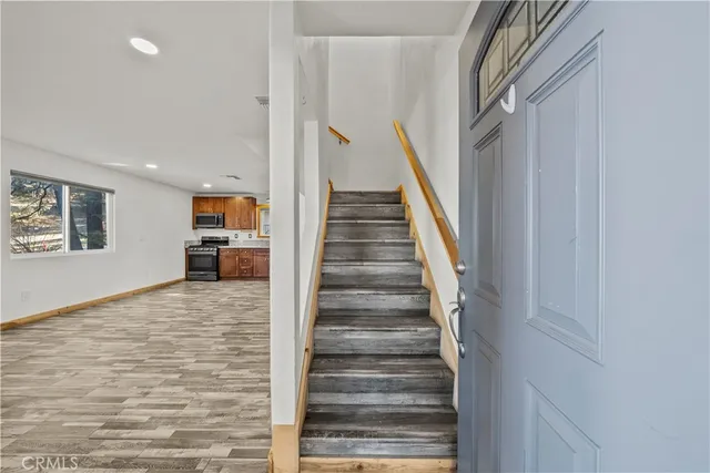 a large kitchen with stainless steel appliances granite countertop a large counter top and a stove top oven