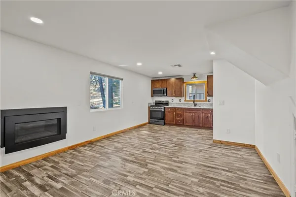 a kitchen with stainless steel appliances granite countertop a stove a sink and a refrigerator