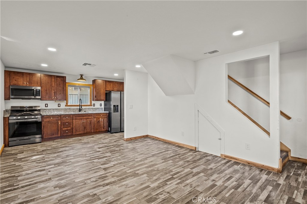714 Paine Road Big Bear Lake, CA 92315 - Photo 24 of 39 a large kitchen with stainless steel appliances granite countertop a large counter top and a stove top oven