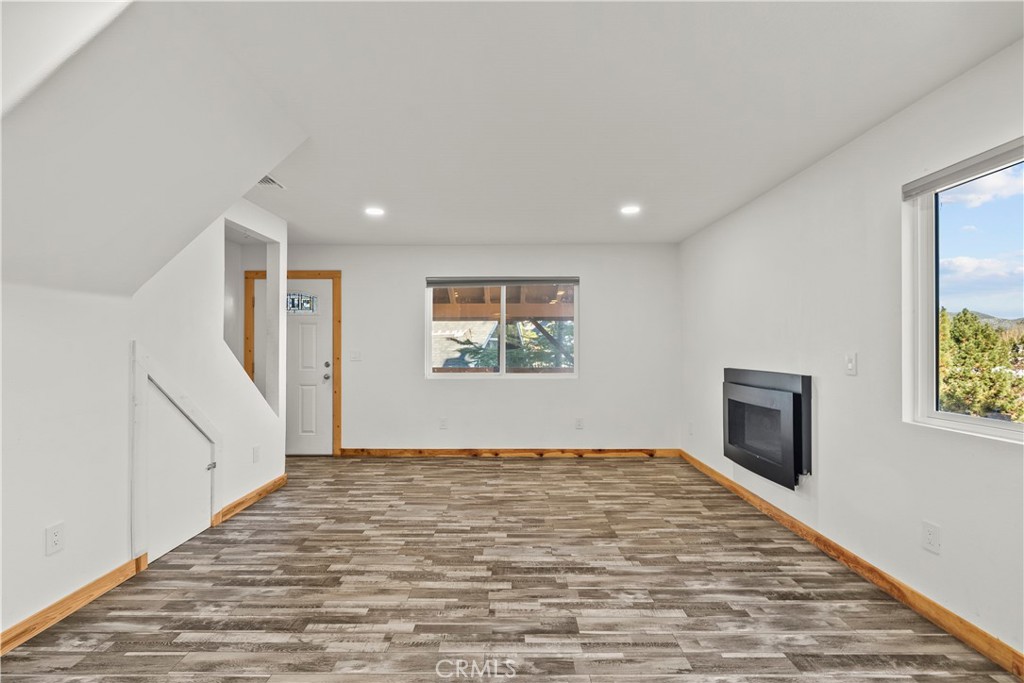 714 Paine Road Big Bear Lake, CA 92315 - Photo 27 of 39 a view of an empty room window and wooden floor