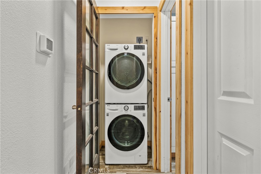 714 Paine Road Big Bear Lake, CA 92315 - Photo 30 of 39 a utility room with dryer washer and a view of bedroom