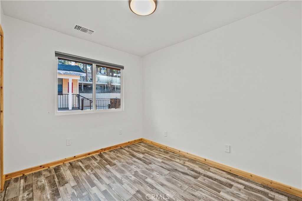 714 Paine Road Big Bear Lake, CA 92315 - Photo 31 of 39 a view of empty room with wooden floor