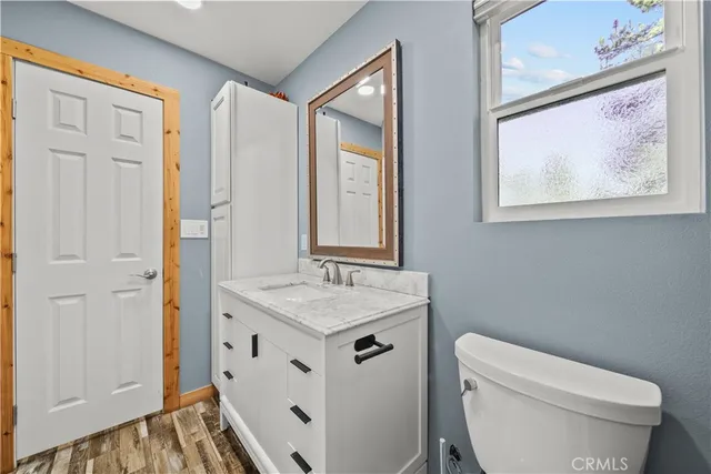 a view of a room with wooden floor and window