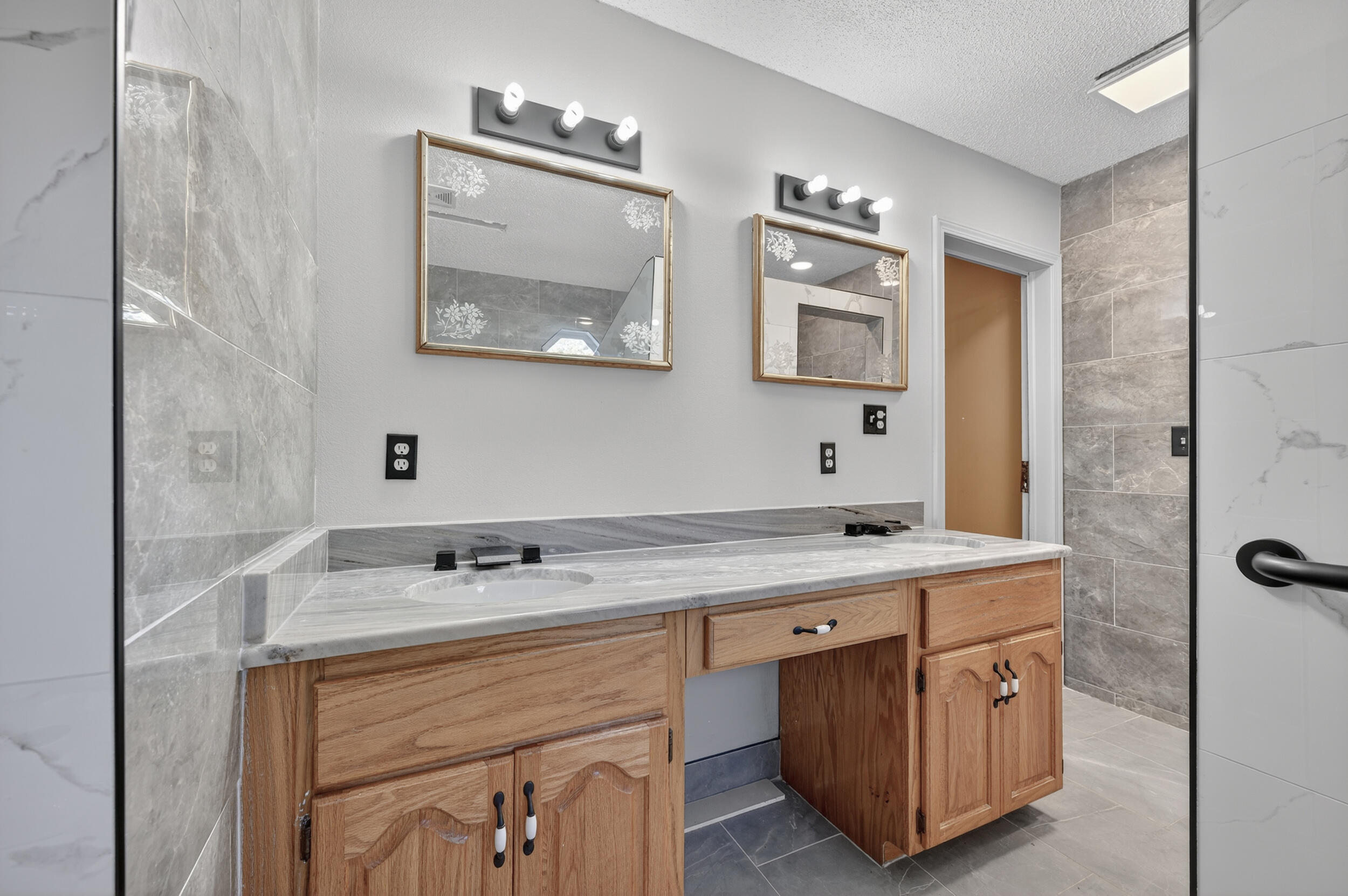 5688 Ridge Avenue Milton, FL 32583 - Photo 12 of 31 a spacious bathroom with a granite countertop sink a mirror and a