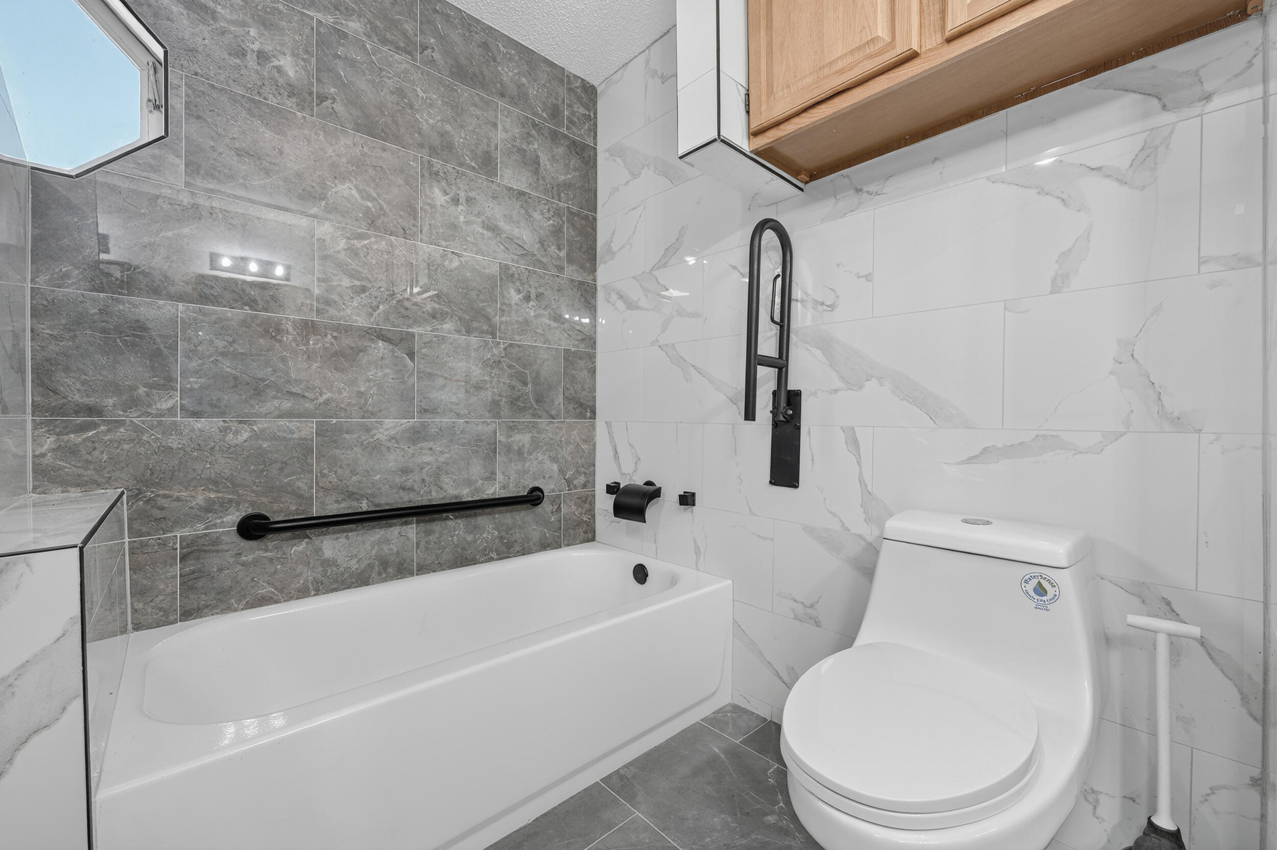5688 Ridge Avenue Milton, FL 32583 - Photo 13 of 31 a white toilet sitting next to a bath tub