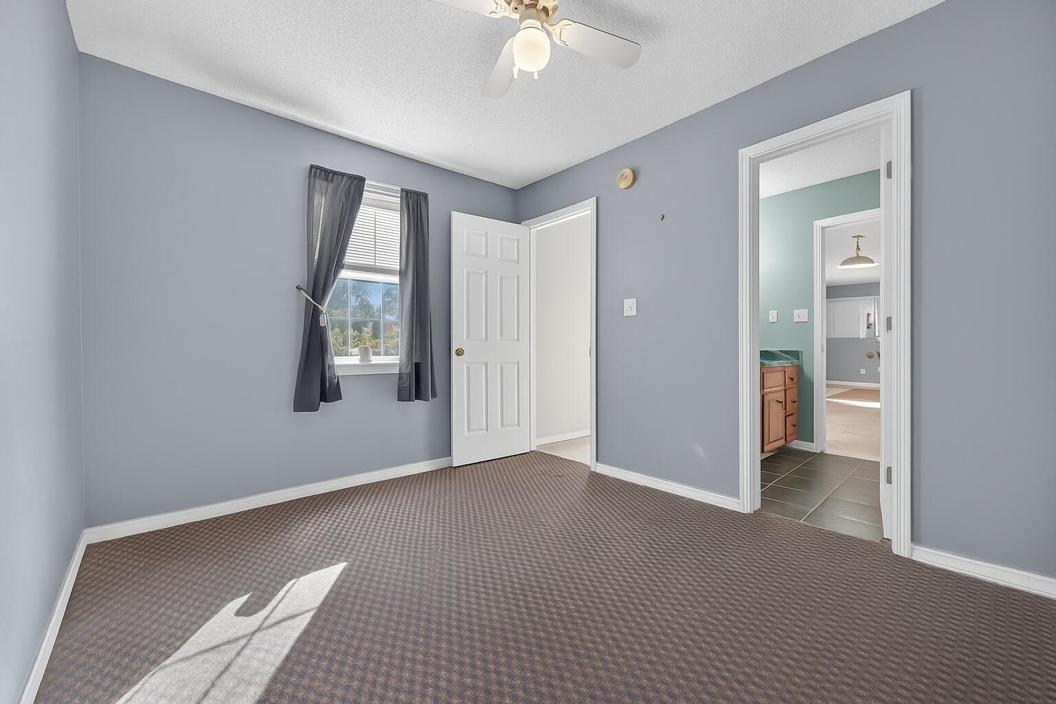 5688 Ridge Avenue Milton, FL 32583 - Photo 14 of 31 an empty room with windows and closet