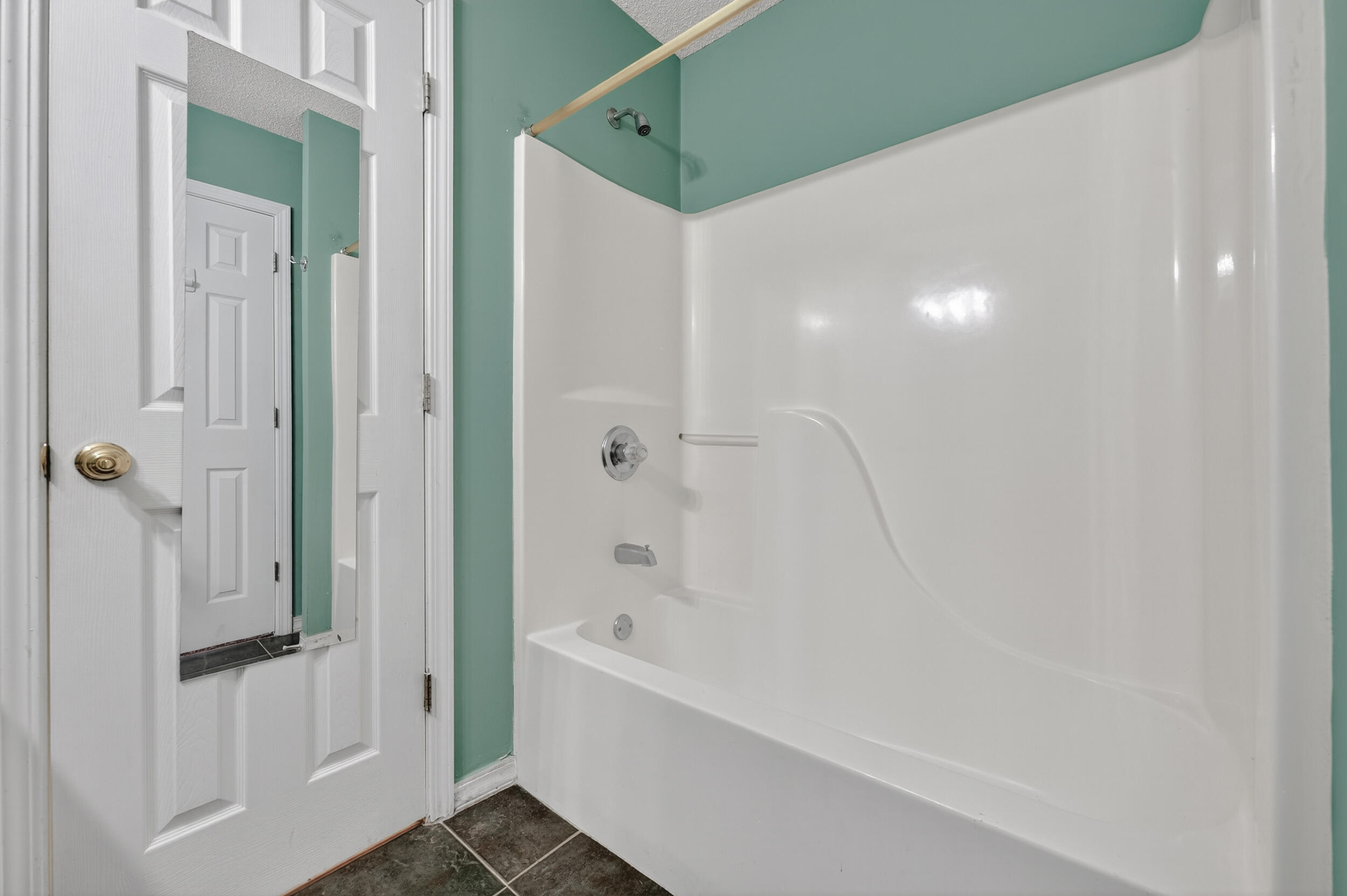 5688 Ridge Avenue Milton, FL 32583 - Photo 16 of 31 a bathroom with a bathtub and a shower
