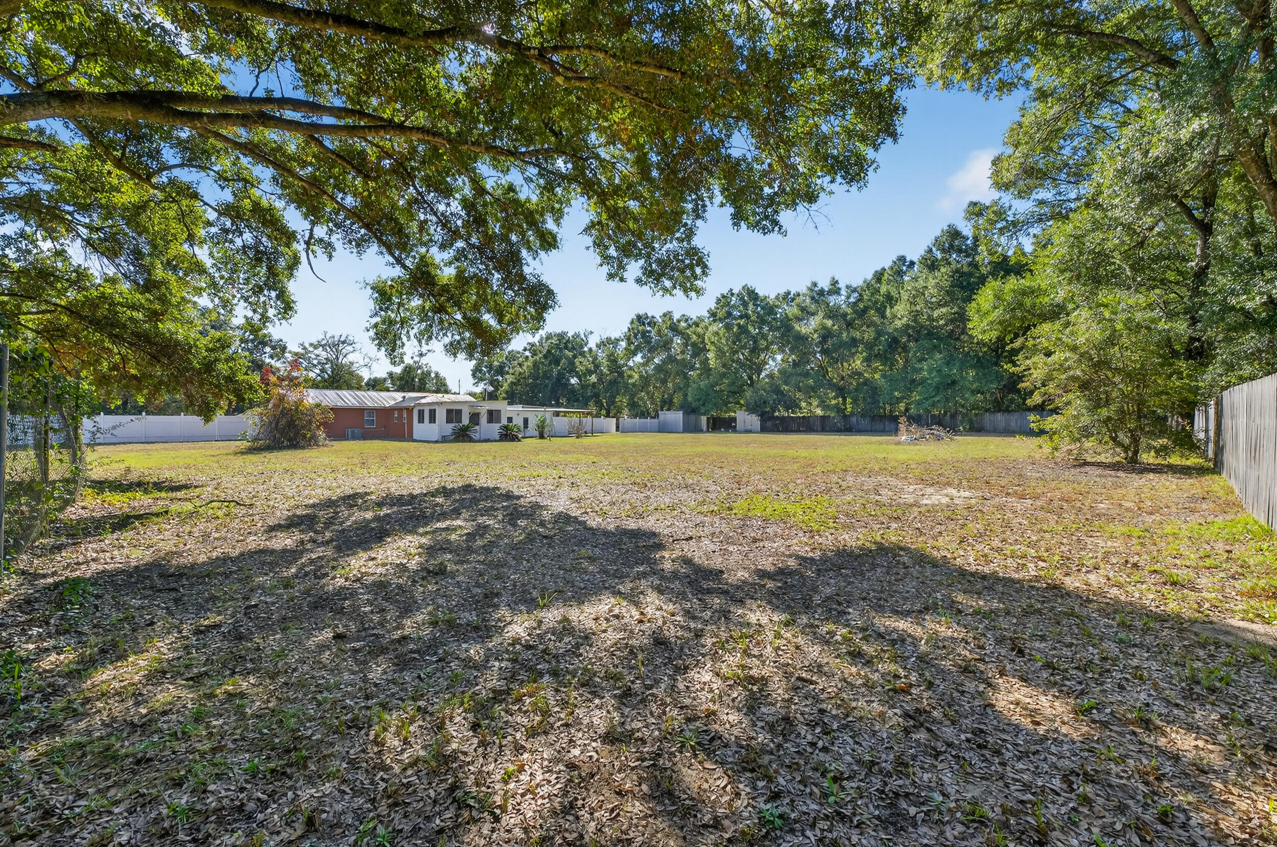5688 Ridge Avenue Milton, FL 32583 - Photo 24 of 31 a view of a lake with a yard and trees