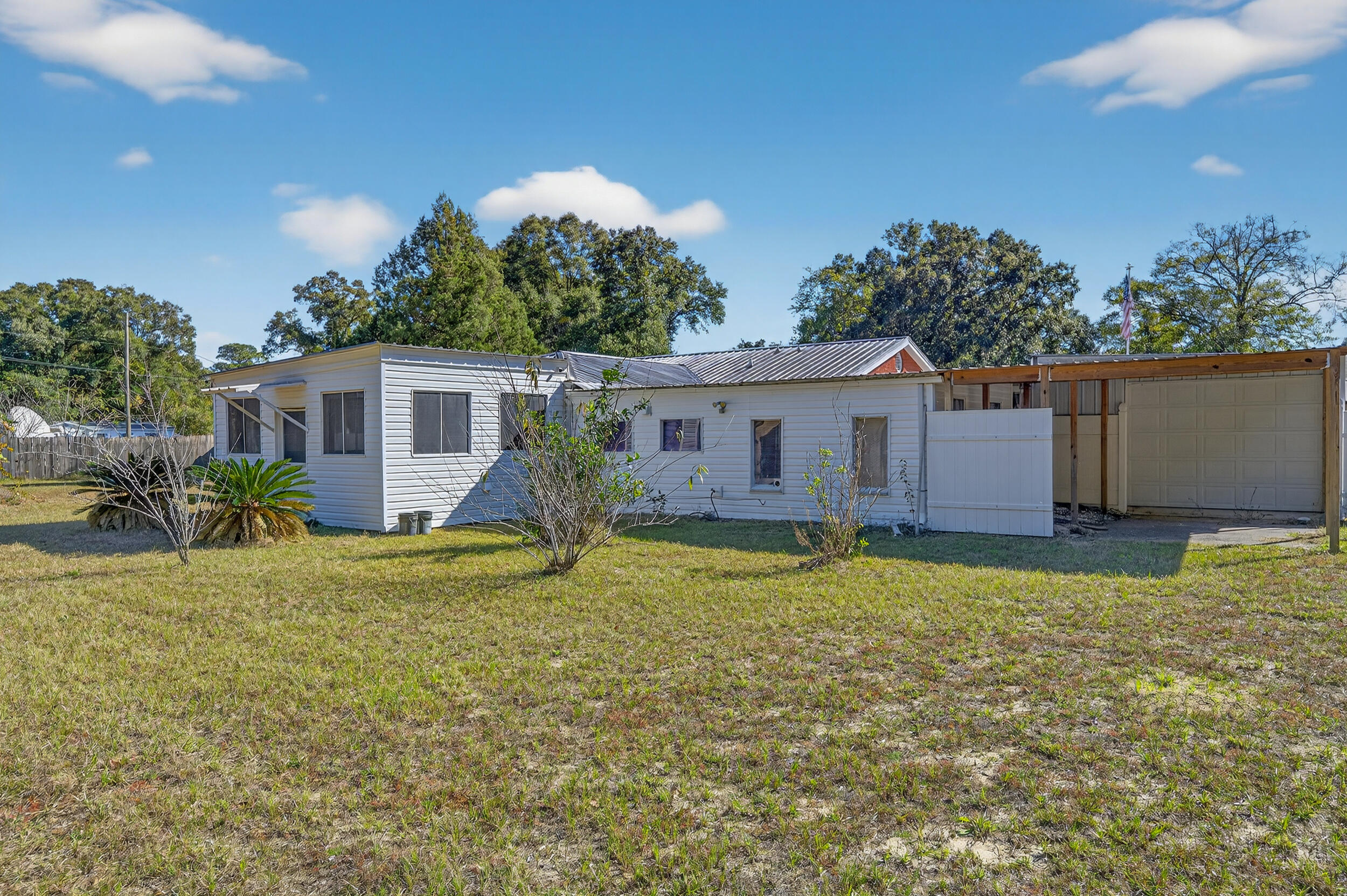 5688 Ridge Avenue Milton, FL 32583 - Photo 26 of 31 a view of a house with a yard and a tree