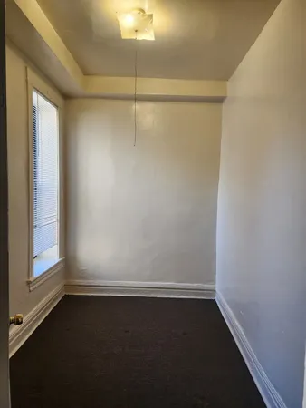 a view of a hallway with wooden floor and entryway