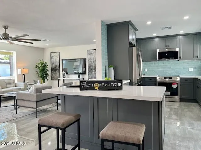a large kitchen with a table and chairs