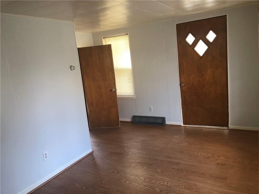1218 Sharon Road Beaver, PA 15009 - Photo 3 of 17 an empty room with wooden floor and mirror