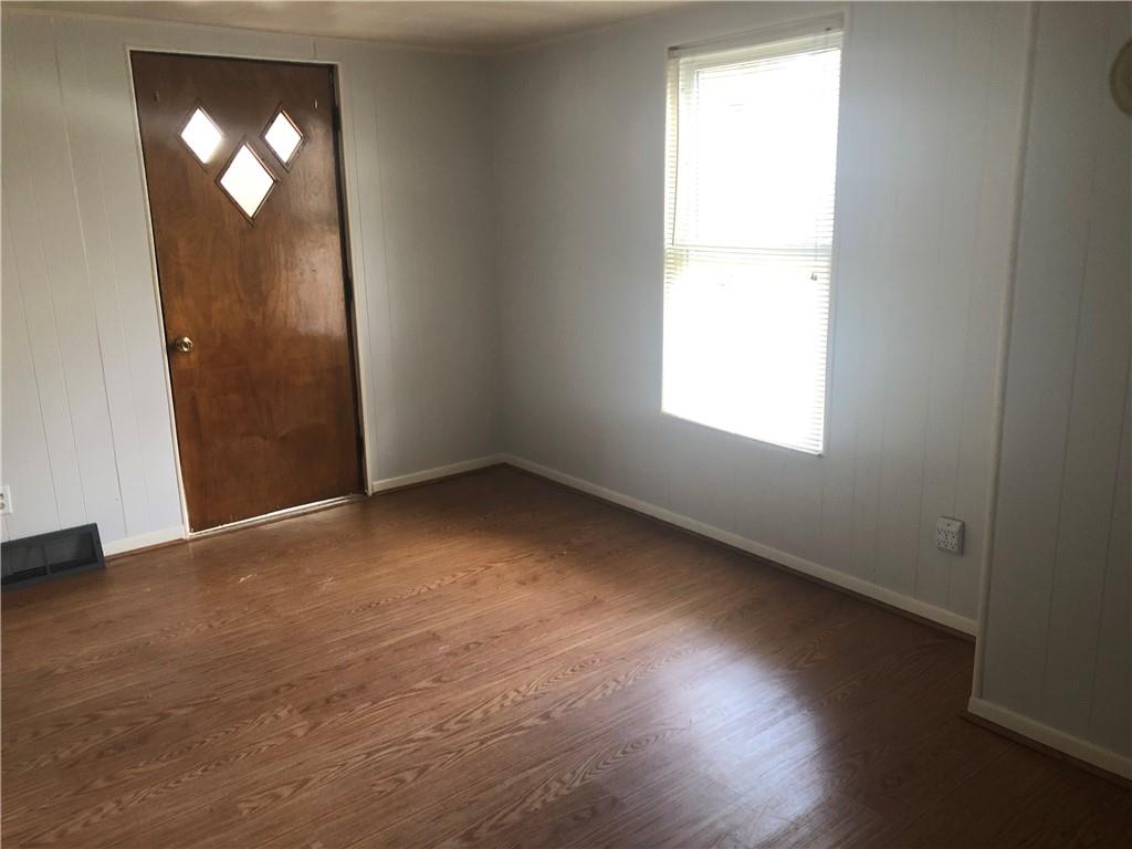 1218 Sharon Road Beaver, PA 15009 - Photo 4 of 17 an empty room with wooden floor and windows