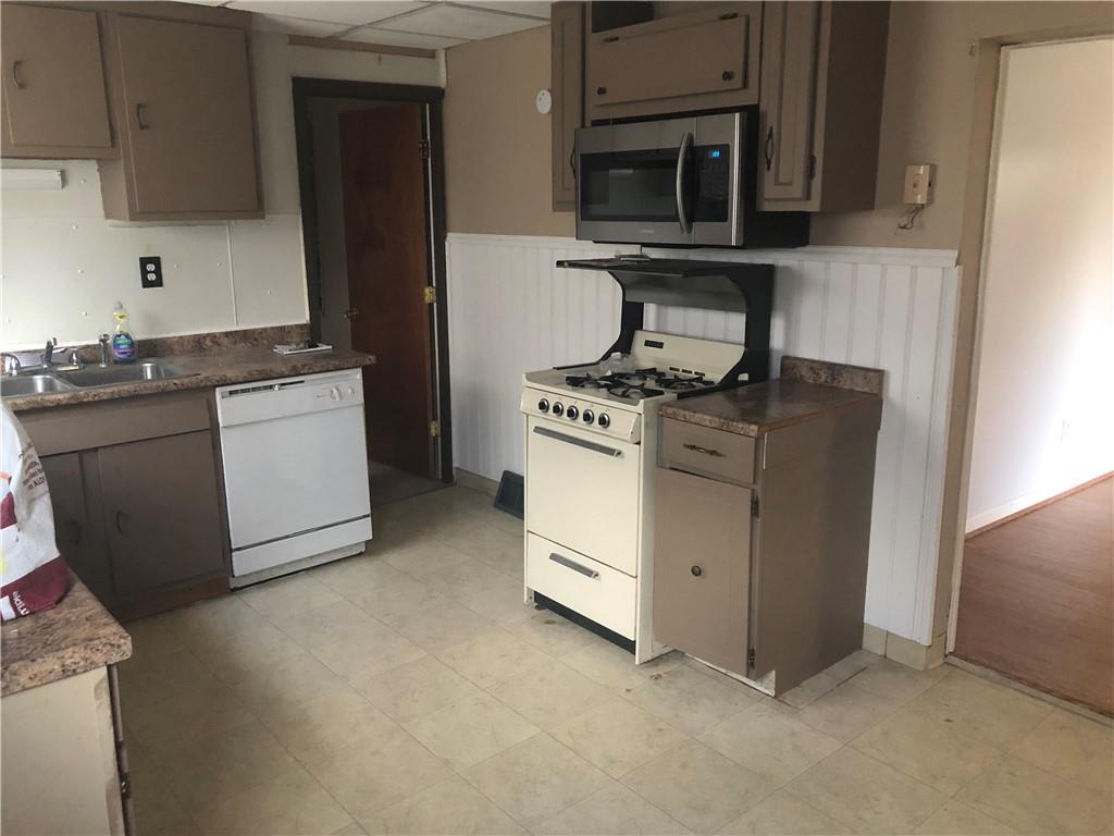 1218 Sharon Road Beaver, PA 15009 - Photo 7 of 17 a kitchen with white cabinets and stainless steel appliances