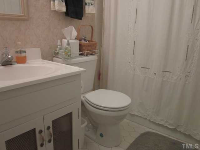 6708 Colony Court Raleigh, NC 27613 - Photo 23 of 25 Second full bath features tile floor, tile tub, updated light fixtures, lights on dimmer & linen closet! Bathroom