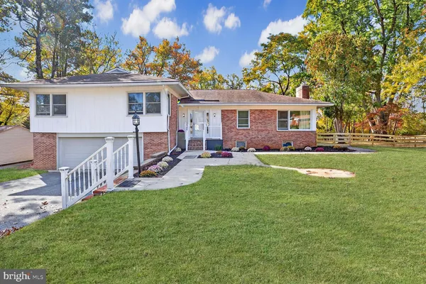 a view of a house with a yard and a patio