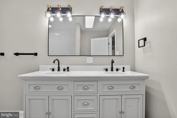 a view of a room with wooden floor and a ceiling fan