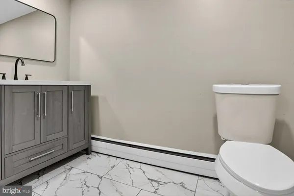 a bathroom with a sink vanity and a mirror