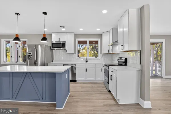 a kitchen with wooden cabinets and center island