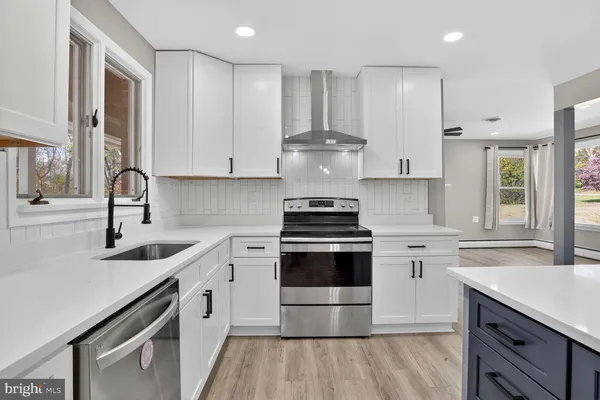 a kitchen with a sink stove and refrigerator