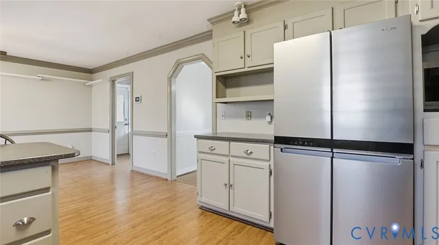 a kitchen with cabinets and a refrigerator