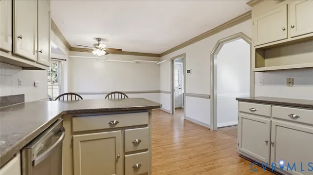 a kitchen with granite countertop a sink cabinets and stainless steel appliances