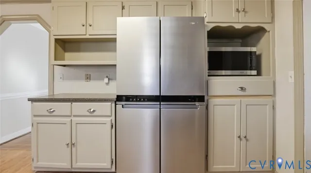 a kitchen with a refrigerator and cabinets