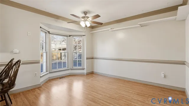 a view of a livingroom with wooden floor and white walls