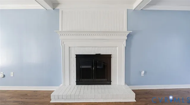 a view of a livingroom with an empty space and a fireplace